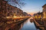 Navigli canals in Milan at sunset with restaurants and lights