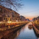 Navigli canals in Milan at sunset with restaurants and lights