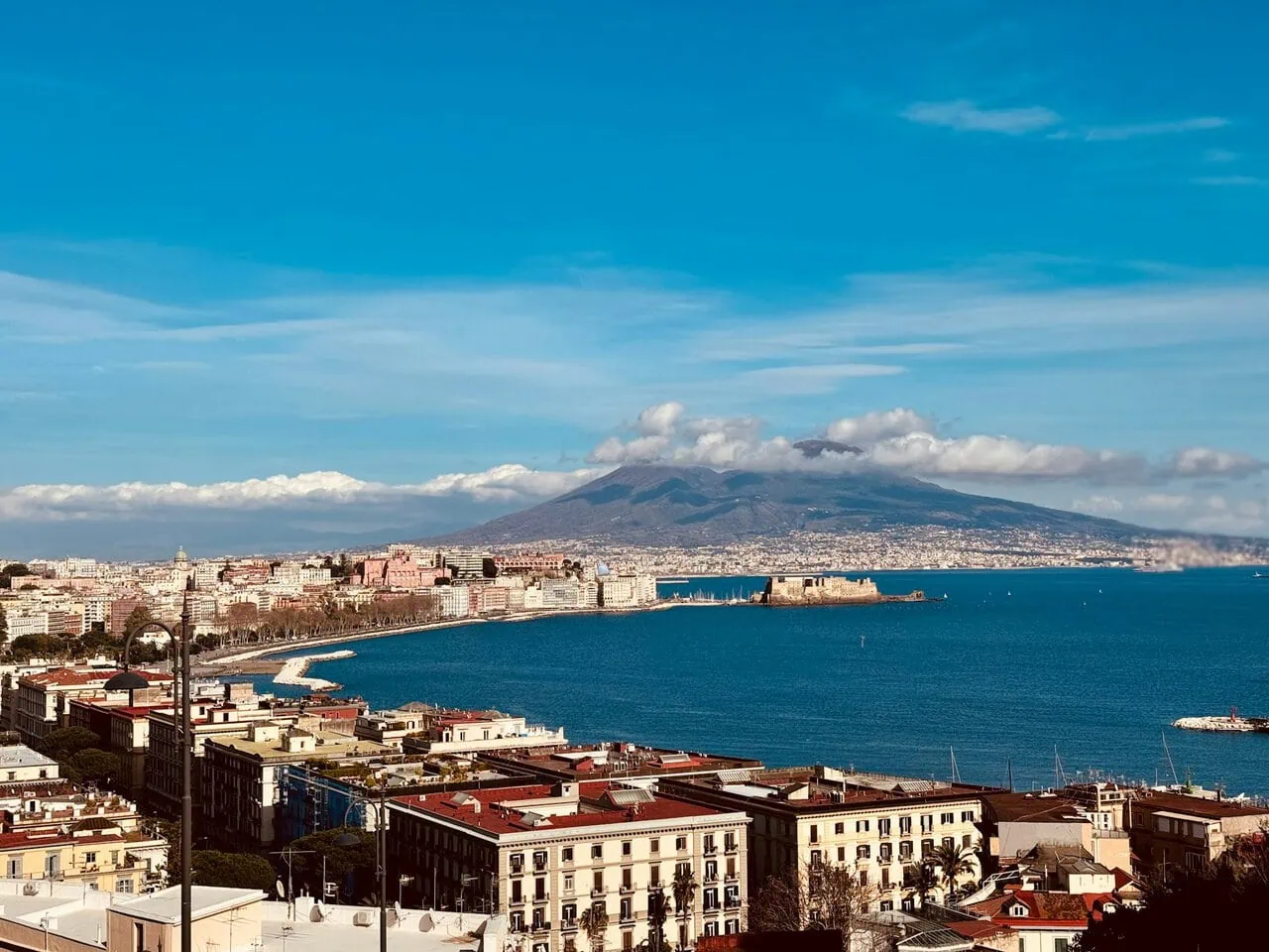 View across Naples and the Bay of Naples with Mount Vesuvius behind the city skyline