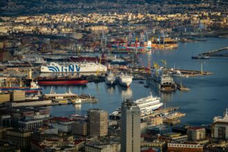 Aerial view of the Port of Naples with large GNV ferries and passenger ships preparing for overnight sailings to Sicily