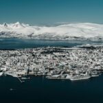 Tromsø skyline covered in snow beside Arctic mountains and fjords in northern Norway