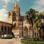 Historic Palermo Cathedral in central Palermo, Sicily, surrounded by palm trees and tourists near the city reached from Palermo Airport