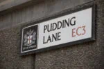 Pudding Lane street sign in the City of London marking the location where the Great Fire of London began in 1666.