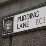Pudding Lane street sign in the City of London marking the location where the Great Fire of London began in 1666.
