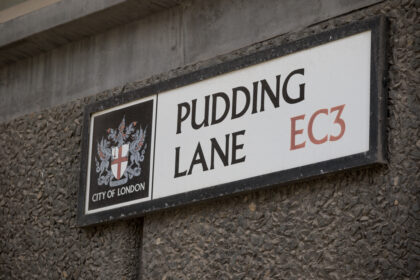 Pudding Lane street sign in the City of London marking the location where the Great Fire of London began in 1666.