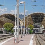 Platforms inside Nice-Ville railway station on the French Riviera with overhead power lines and historic station roof structure
