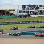 Formula One cars racing through a corner at Silverstone Circuit during a race weekend