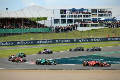 Formula One cars racing through a corner at Silverstone Circuit during a race weekend