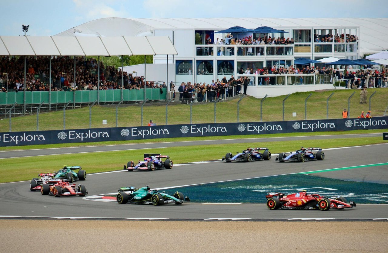 Formula One cars racing through a corner at Silverstone Circuit during a race weekend