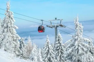 Skiing in Poland with gondola lift and snow-covered forest in mountain resort
