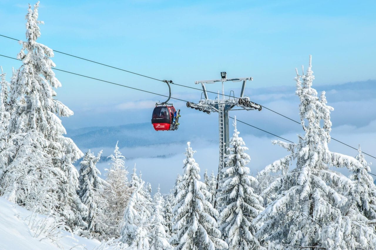 Skiing in Poland with gondola lift and snow-covered forest in mountain resort