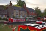 Traditional narrowboats moored on the Grand Union Canal at Stoke Bruerne