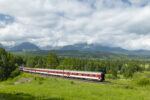 Long-distance train passing beneath the High Tatras mountains in northern Slovakia