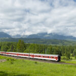 Long-distance train passing beneath the High Tatras mountains in northern Slovakia
