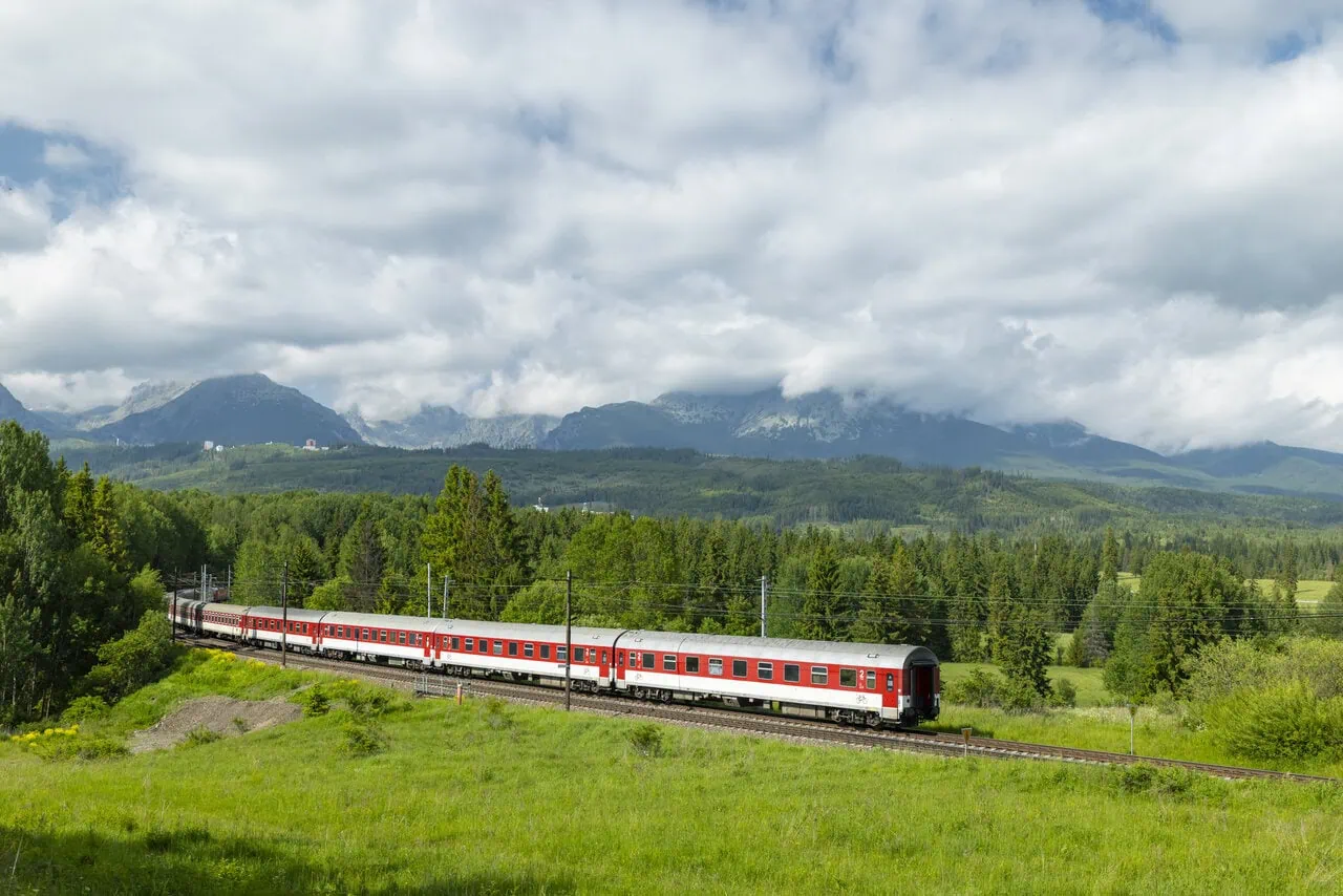 Long-distance train passing beneath the High Tatras mountains in northern Slovakia