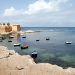 Coastal harbour and historic waterfront near Trapani in western Sicily, with fishing boats and Mediterranean sea views close to Trapani Airport