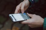Traveller using smartphone abroad with travel eSIM connectivity and mobile data apps