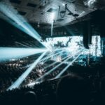 Large live concert arena in Vienna with stage lighting and crowds during Eurovision style music event