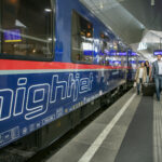 Nightjet overnight sleeper train at Vienna Hauptbahnhof platform with passengers boarding in Austria