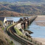 Cambrian Line railway crossing Barmouth Bridge over estuary in North Wales