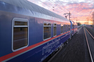 Nightjet sleeper train from Amsterdam travelling through Europe at sunrise
