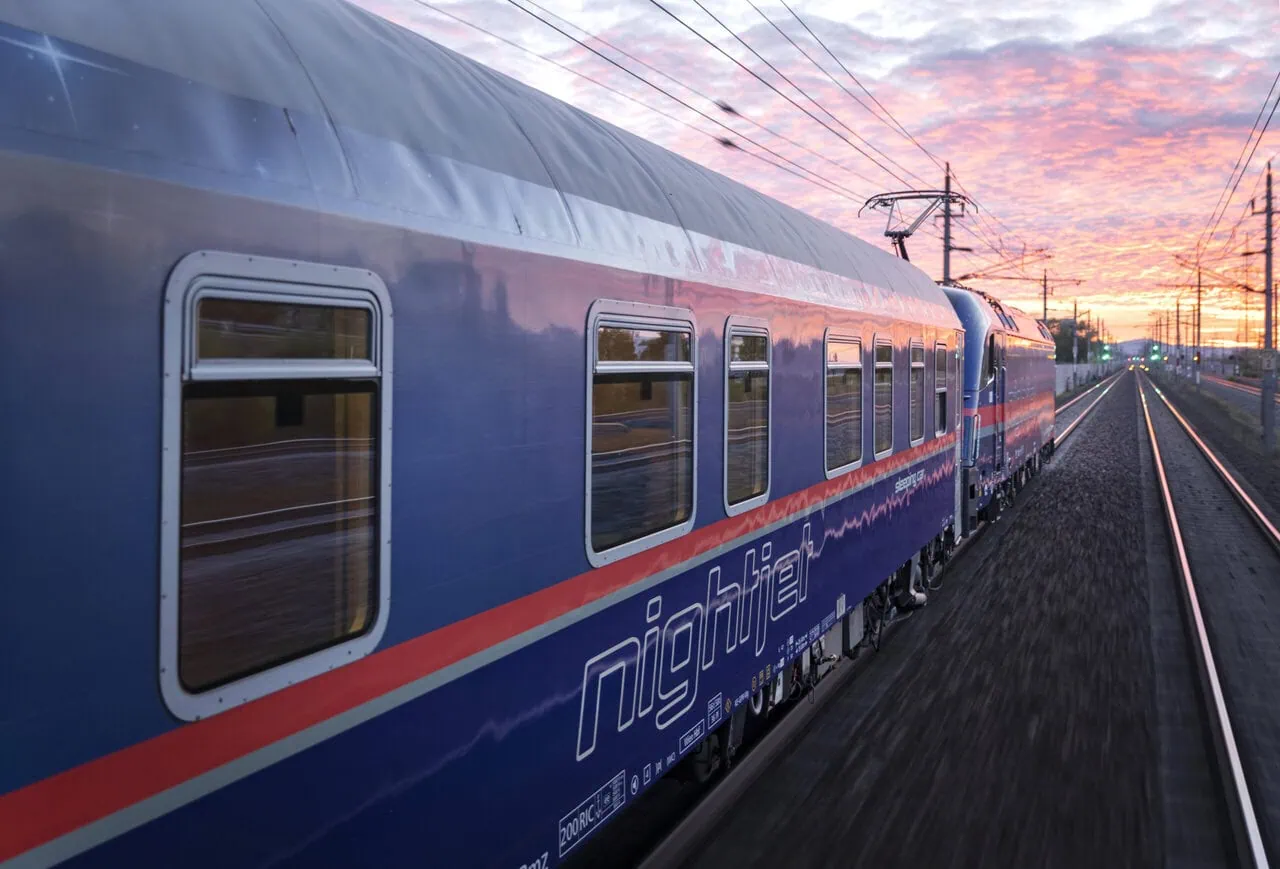 Nightjet sleeper train from Amsterdam travelling through Europe at sunrise