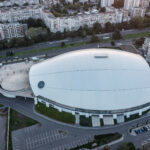Aerial view of Arena Burgas showing the modern indoor arena, surrounding roads, parking areas, and residential districts in Burgas, Bulgaria.