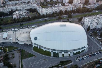 Aerial view of Arena Burgas showing the modern indoor arena, surrounding roads, parking areas, and residential districts in Burgas, Bulgaria.