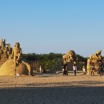 Visitors exploring sand sculptures at the Burgas Sand Festival.