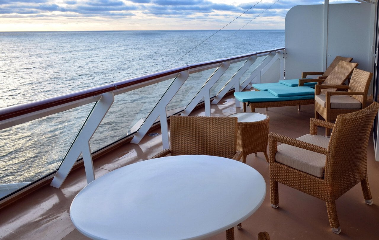 Private balcony cabin overlooking the ocean on a modern cruise ship