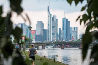View of Frankfurt's modern skyline and financial district from the banks of the River Main in Germany.