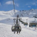 Ski lift operating in a snow-covered Tyrolean ski resort near Innsbruck.