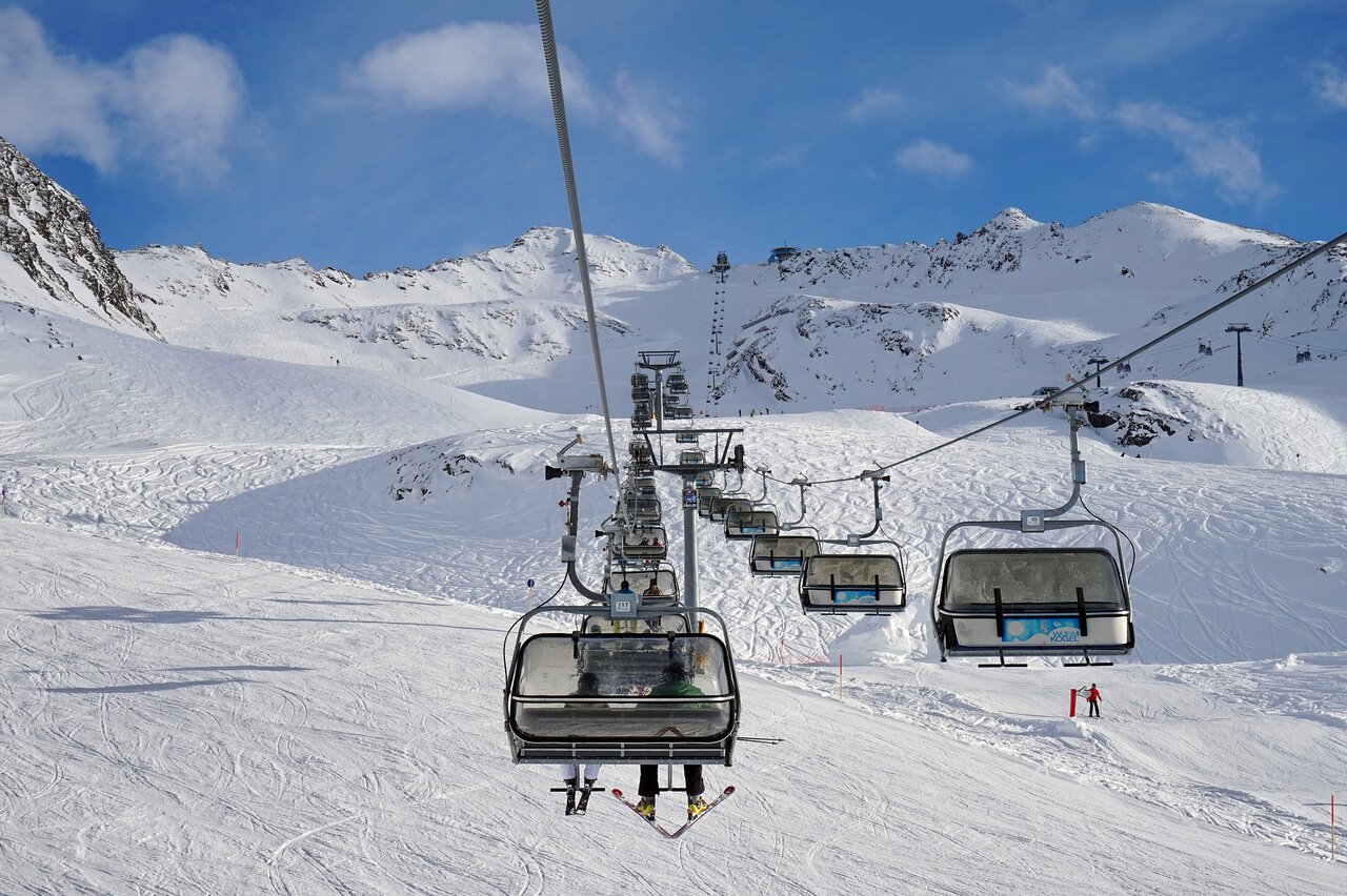 Ski lift operating in a snow-covered Tyrolean ski resort near Innsbruck.