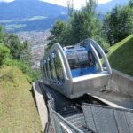Hungerburg funicular climbing above Innsbruck with panoramic city views below.