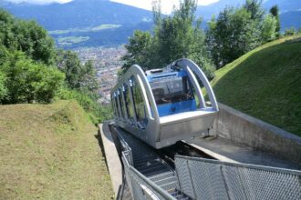 Hungerburg funicular climbing above Innsbruck with panoramic city views below.