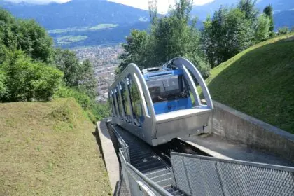 Hungerburg funicular climbing above Innsbruck with panoramic city views below.