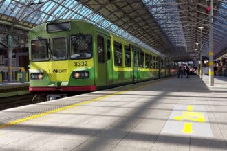 Green DART commuter train at Dublin Connolly Station in Ireland, useful for guides explaining Irish rail passes and train travel.