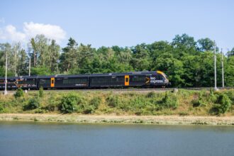Leo Express train travelling through the Czech countryside on an international route between Prague, Kraków, Košice and Frankfurt Airport.