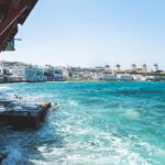 View across the waterfront towards the famous windmills of Mykonos, Greece, featured in the Mykonos Airport Transfers Guide.