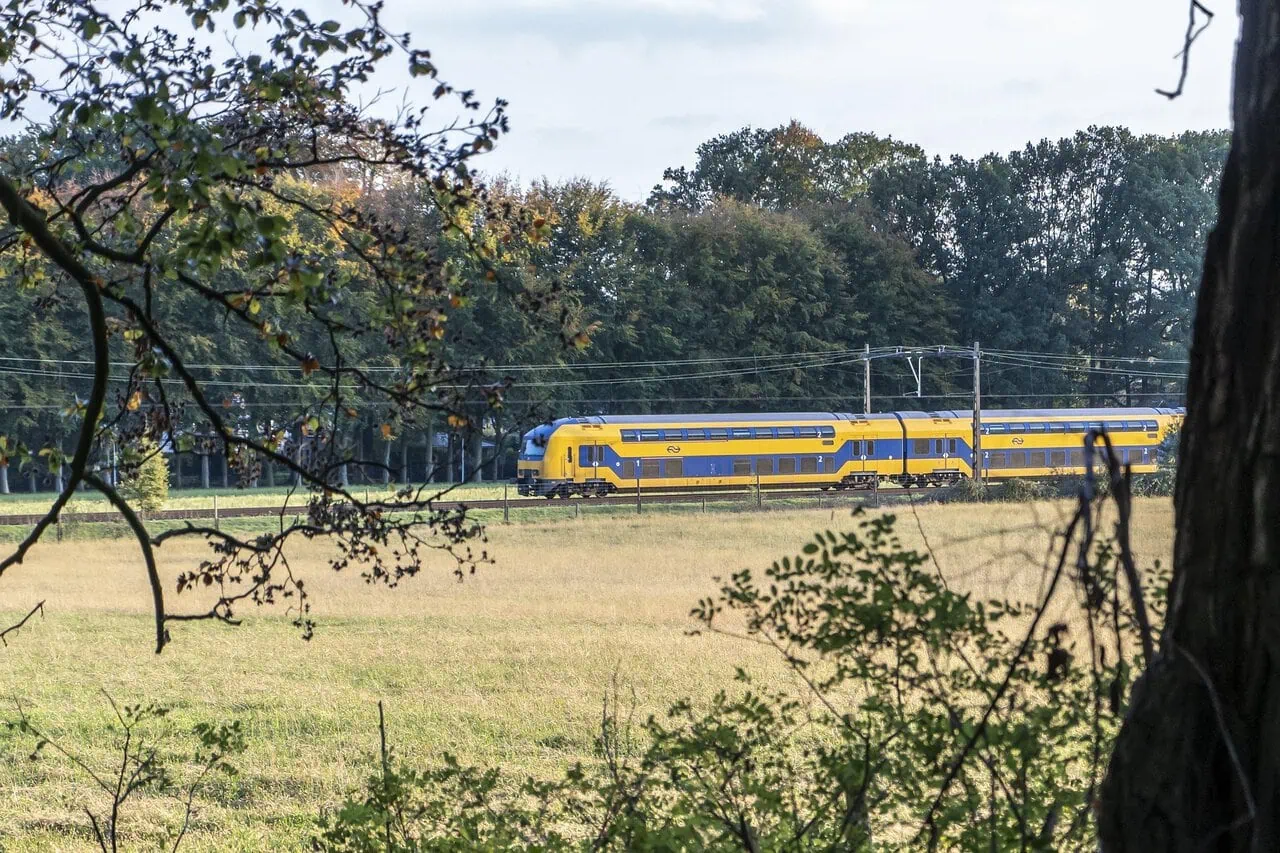 NS Intercity train travelling through the Dutch countryside for the NS Day Ticket Guide