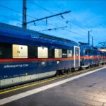 ÖBB Nightjet sleeper train waiting at Innsbruck Hauptbahnhof during the evening.