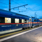 ÖBB Nightjet sleeper train waiting at Innsbruck Hauptbahnhof during the evening.