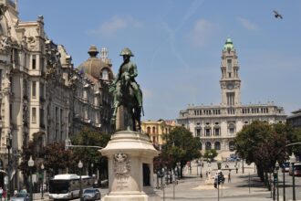 Statue of King Pedro IV in Avenida dos Aliados with Porto City Hall in the background.