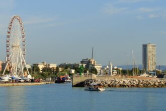 Rimini harbour with the famous Ferris wheel, marina, lighthouse and Adriatic waterfront on Italy's Adriatic coast.