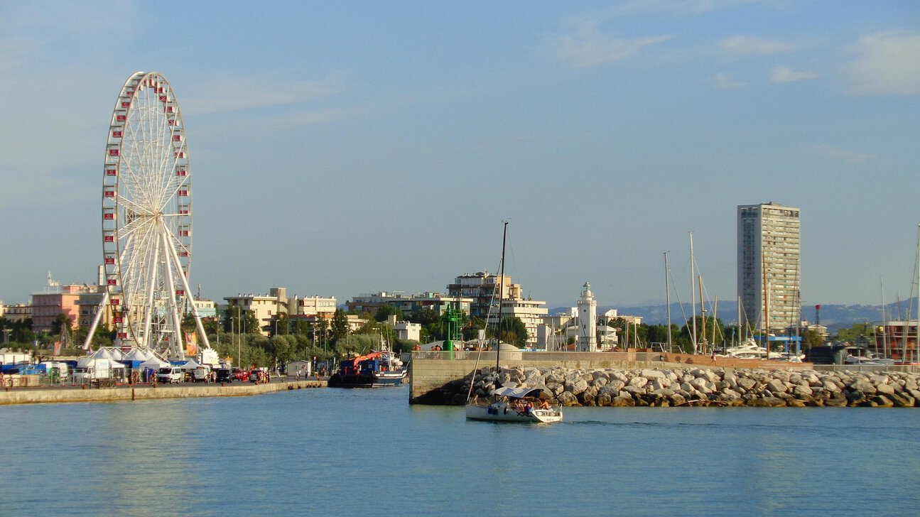 Rimini harbour with the famous Ferris wheel, marina, lighthouse and Adriatic waterfront on Italy's Adriatic coast.