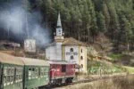 Septemvri to Dobrinishte narrow-gauge train passing through a mountain village in Bulgaria