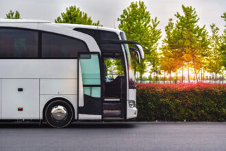 Terravision-style airport transfer coach parked beside a road, representing affordable airport bus services across Europe.