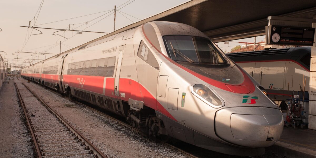 Trenitalia Frecciarossa 1000 high-speed train waiting at a station platform in Italy.