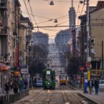 Tram travelling through central Sofia with city buildings and busy streets.