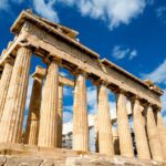 The Parthenon on the Acropolis of Athens beneath a bright blue sky.